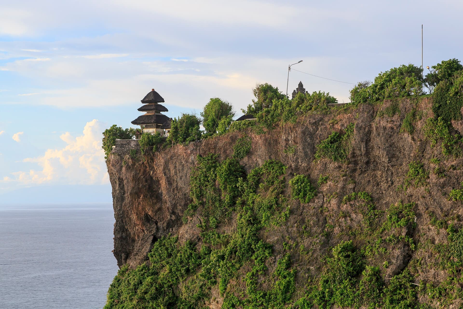 Weathered stone walls of Pura Luhur Uluwatu above the sea, Bali