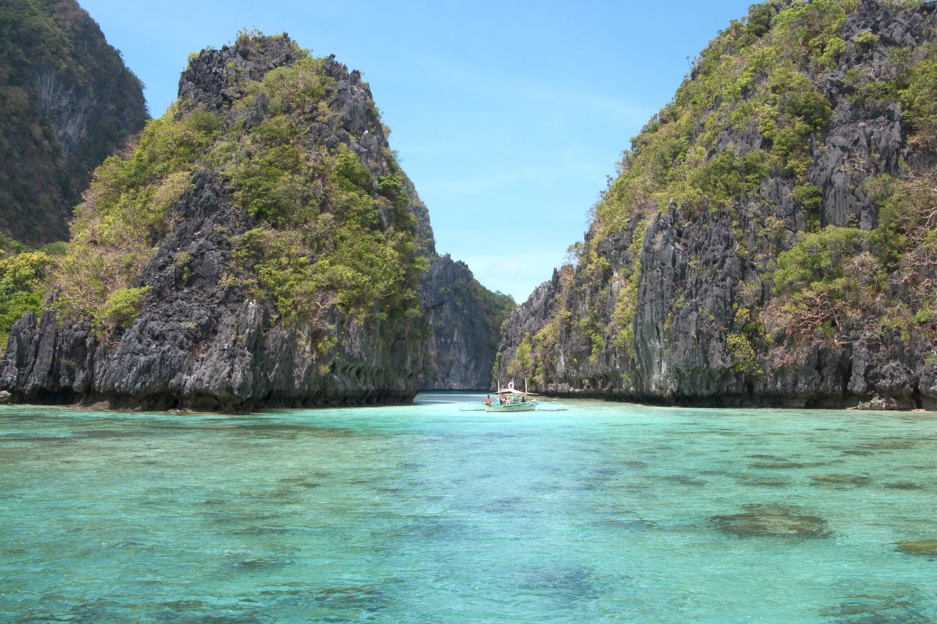 A quiet island lagoon of clear water in Bacuit Bay, El Nido